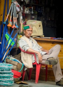 A local trader sits outside his shop in Manali Mall Road