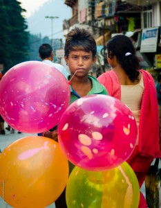 Innocence in the eyes of a child balloon seller in Manali